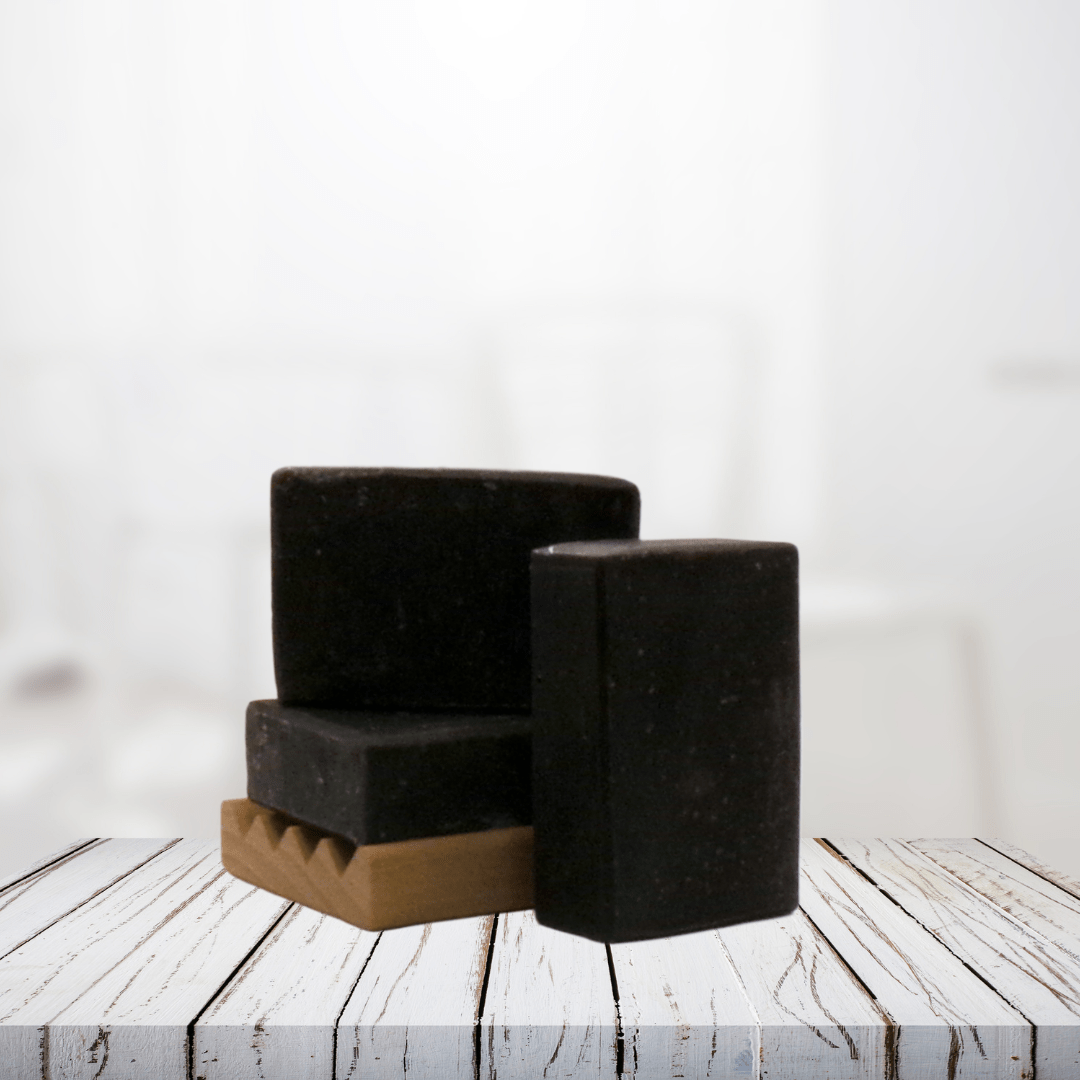 Natural soap bars with activated charcoal on wooden surface.