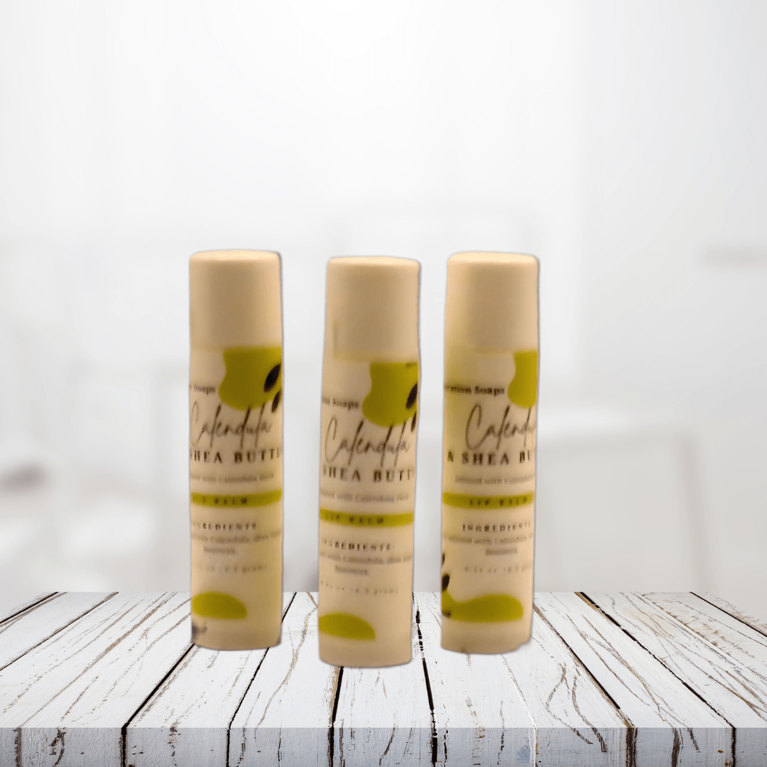 Calendula and Shea Butter Lip Balm on wooden surface, provides deep hydration and healing for chapped lips.