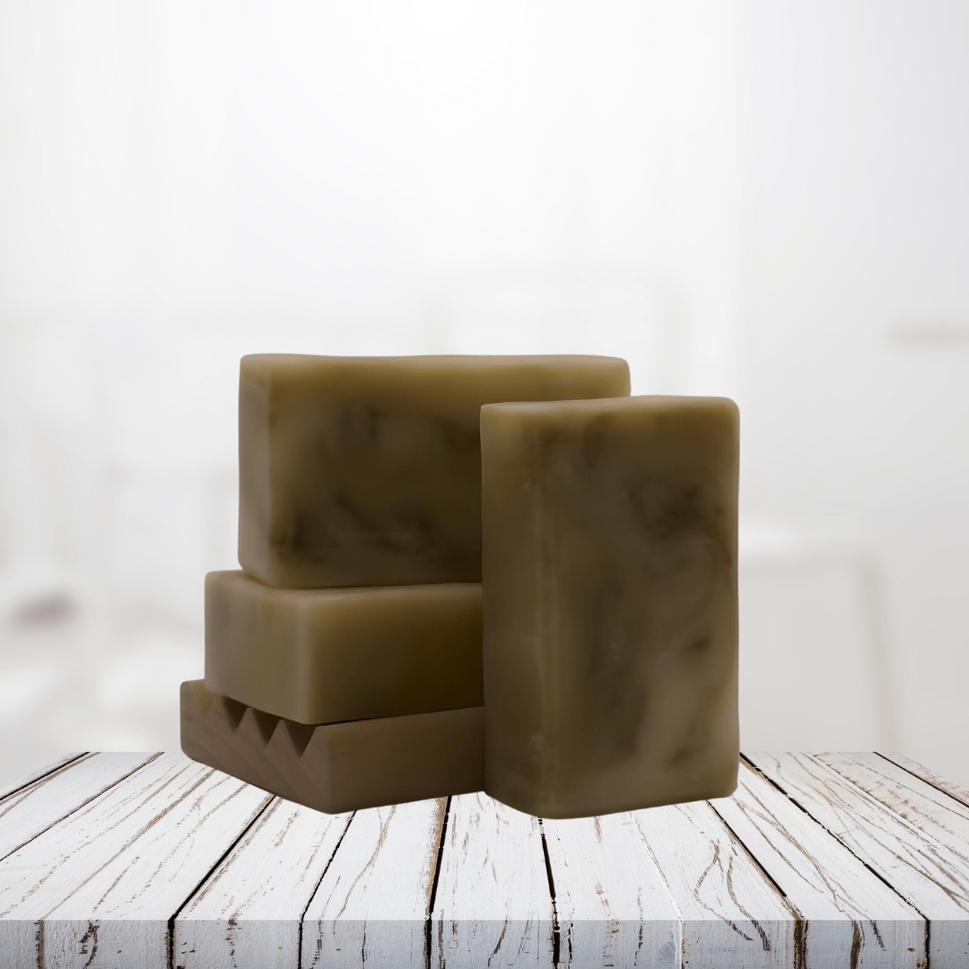 Natural soap bars infused with elderflowers and lavender on a wooden surface.