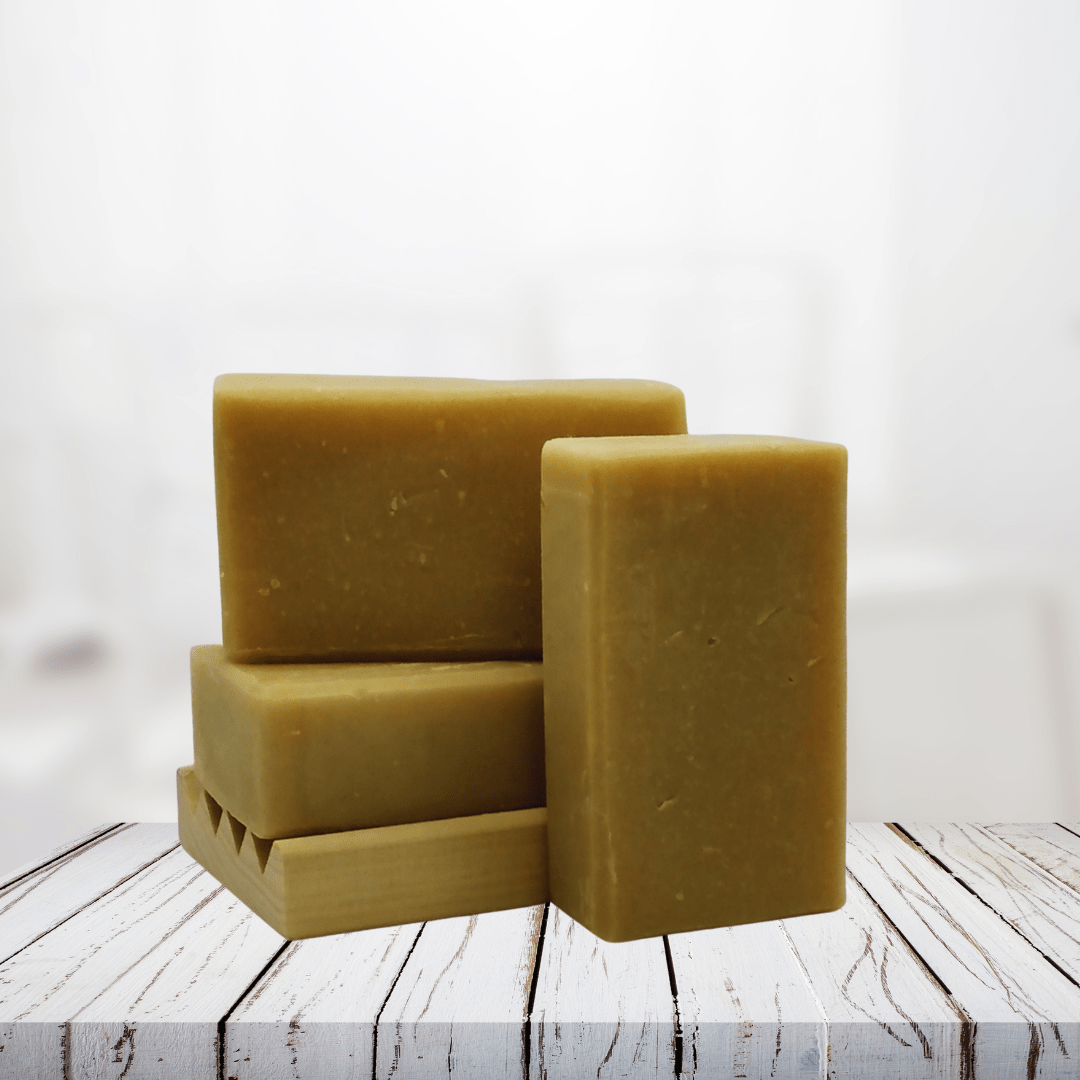 Natural soap bars for men with lavender, patchouli, and cedarwood on a wooden surface.