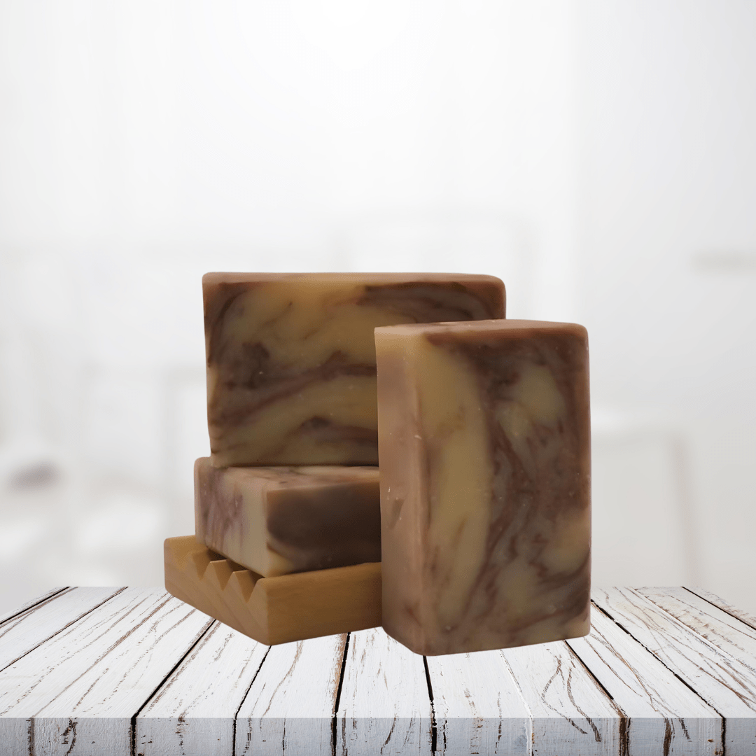 Natural soap bars with lavender and bergamot on a wooden dish.