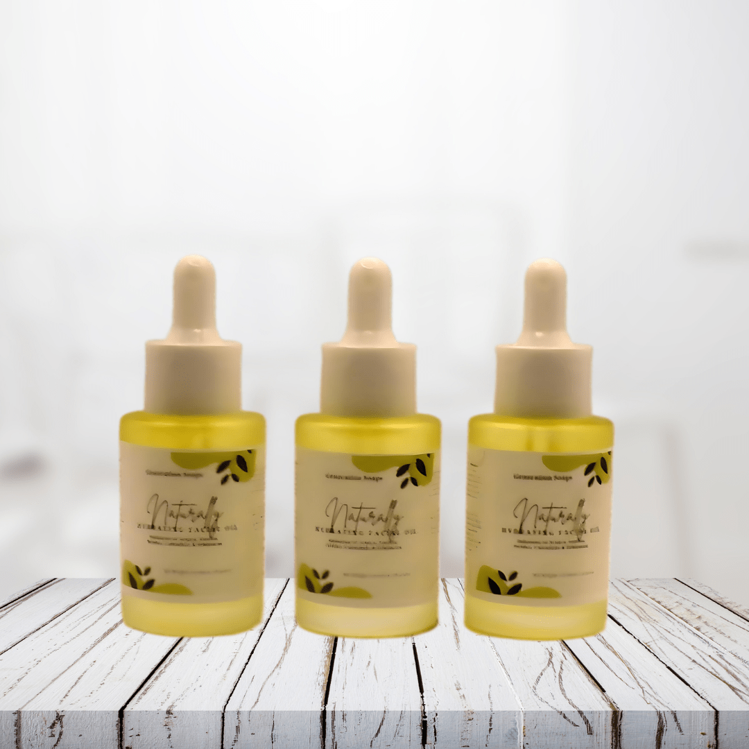 Three bottles of Naturally Hydrating Facial Oil with dropper lids on a wooden surface.