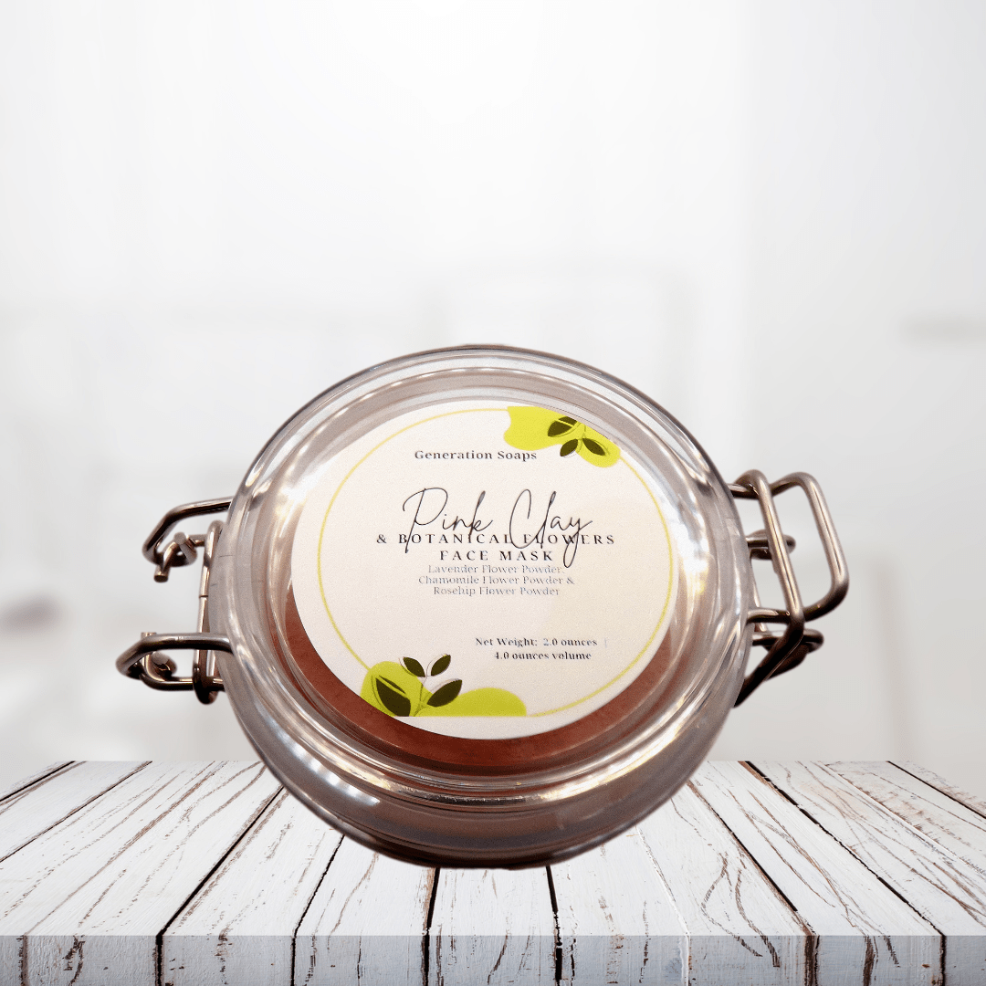 Pink Clay and Botanical Flowers Face Mask in a glass jar on a wooden surface.