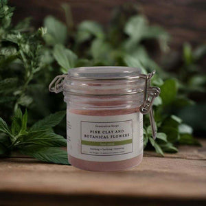 Pink clay and botanical flowers face mask powder with floral ingredients for soothing and clarifying skin care