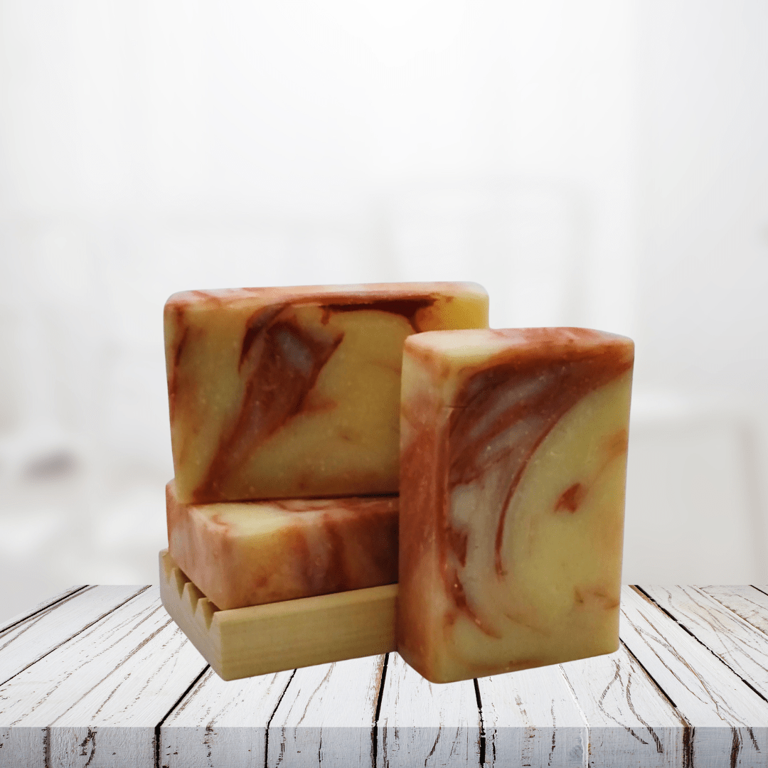 Natural soap bars with pink grapefruit and eucalyptus, showcasing a marbled design on a wooden soap dish.