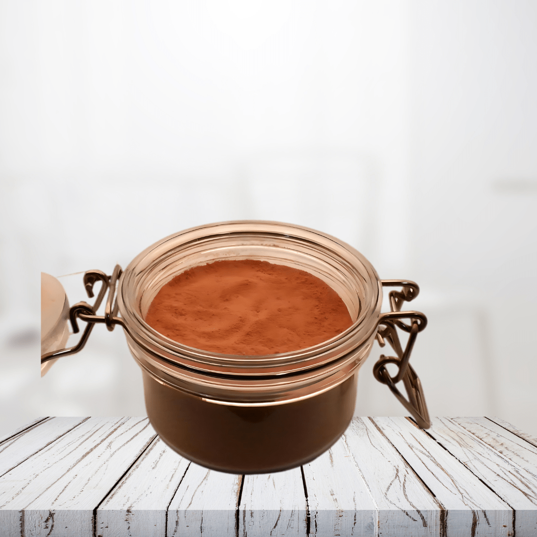 Pink Clay and Botanical Flowers Face Mask in a glass jar on a wooden surface.