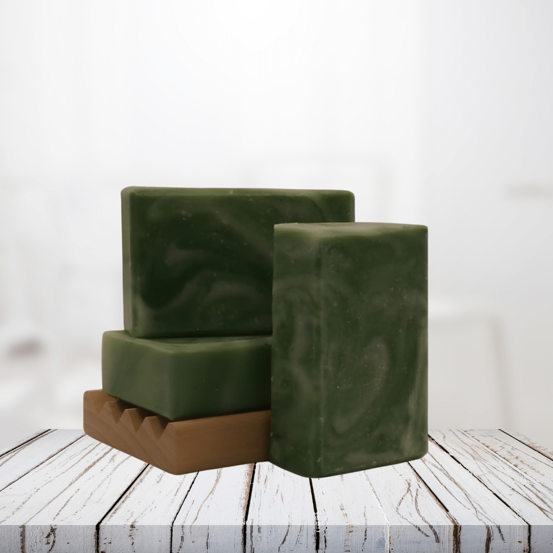 Natural soap bars with plantain and aloe, green color, on wooden surface.