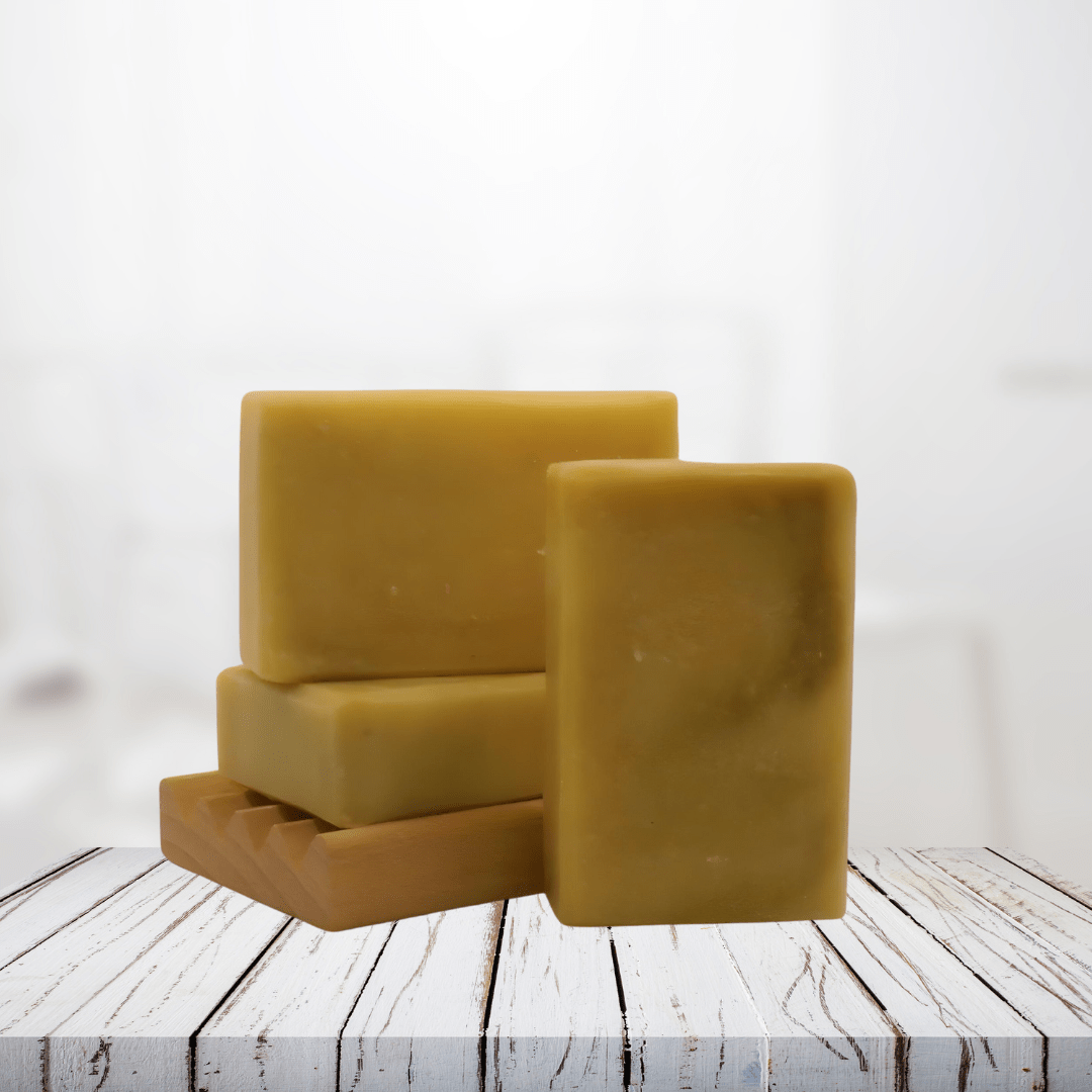 Natural soap bars infused with chickweed, positioned on a wooden surface, suitable for soothing sensitive skin.