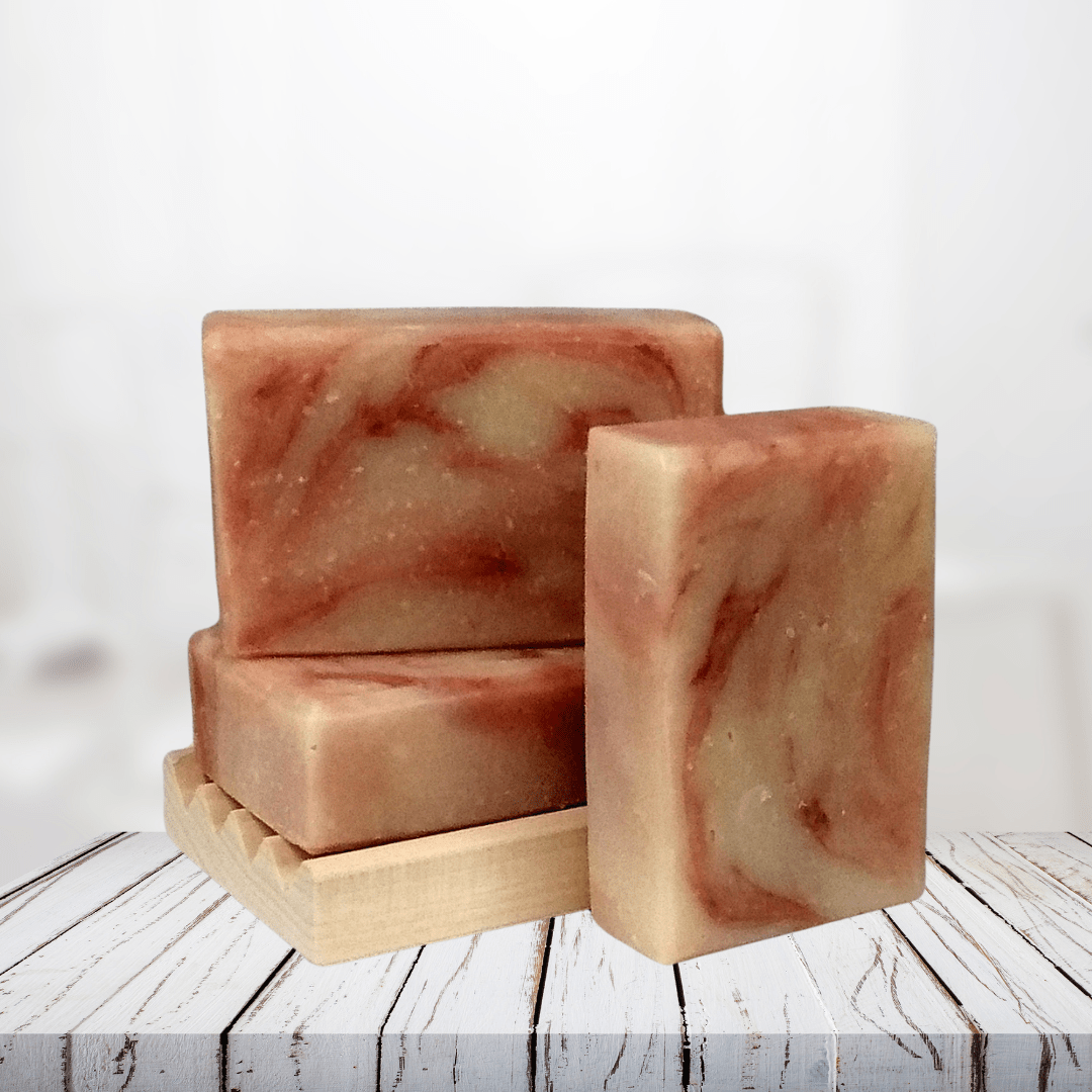 Natural soap bars on wooden soap dish with yarrow and rose swirl pattern.