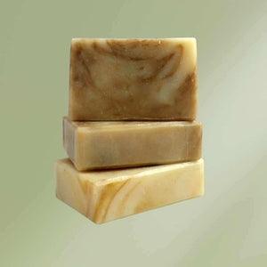 Natural soap bar labeled Cedarwood Lime for Men with packaging on wooden surface