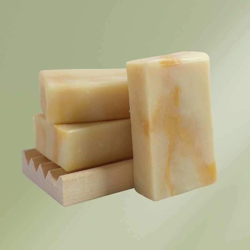 Bar of natural soap named Dancing Dandelions with orange and lavender accents