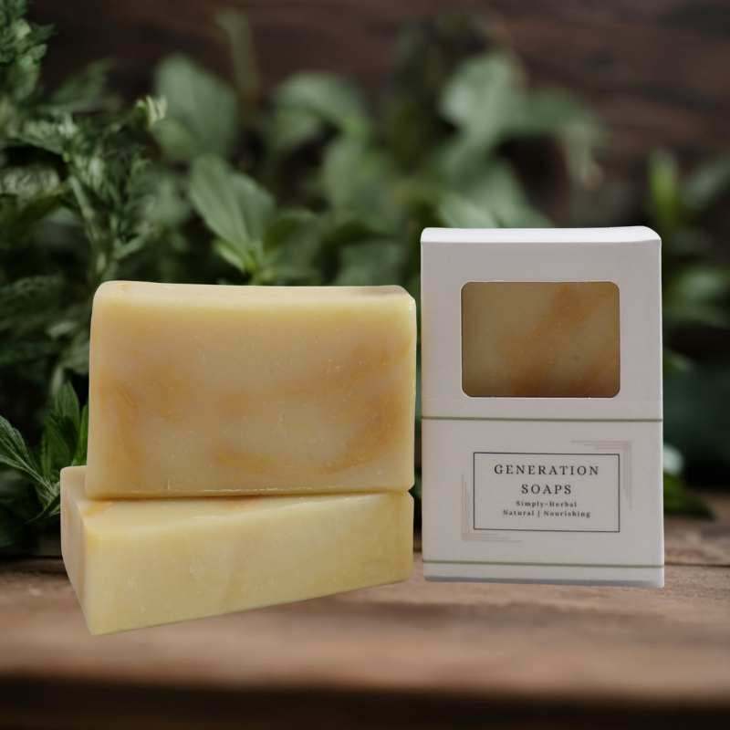 Bar of natural soap named Dancing Dandelions with orange and lavender accents