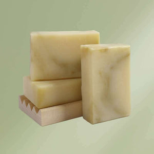 Natural soap bar infused with elderflowers, lavender, bergamot, rosemary, shea butter, and olive oil for soothing and moisturizing skin care.