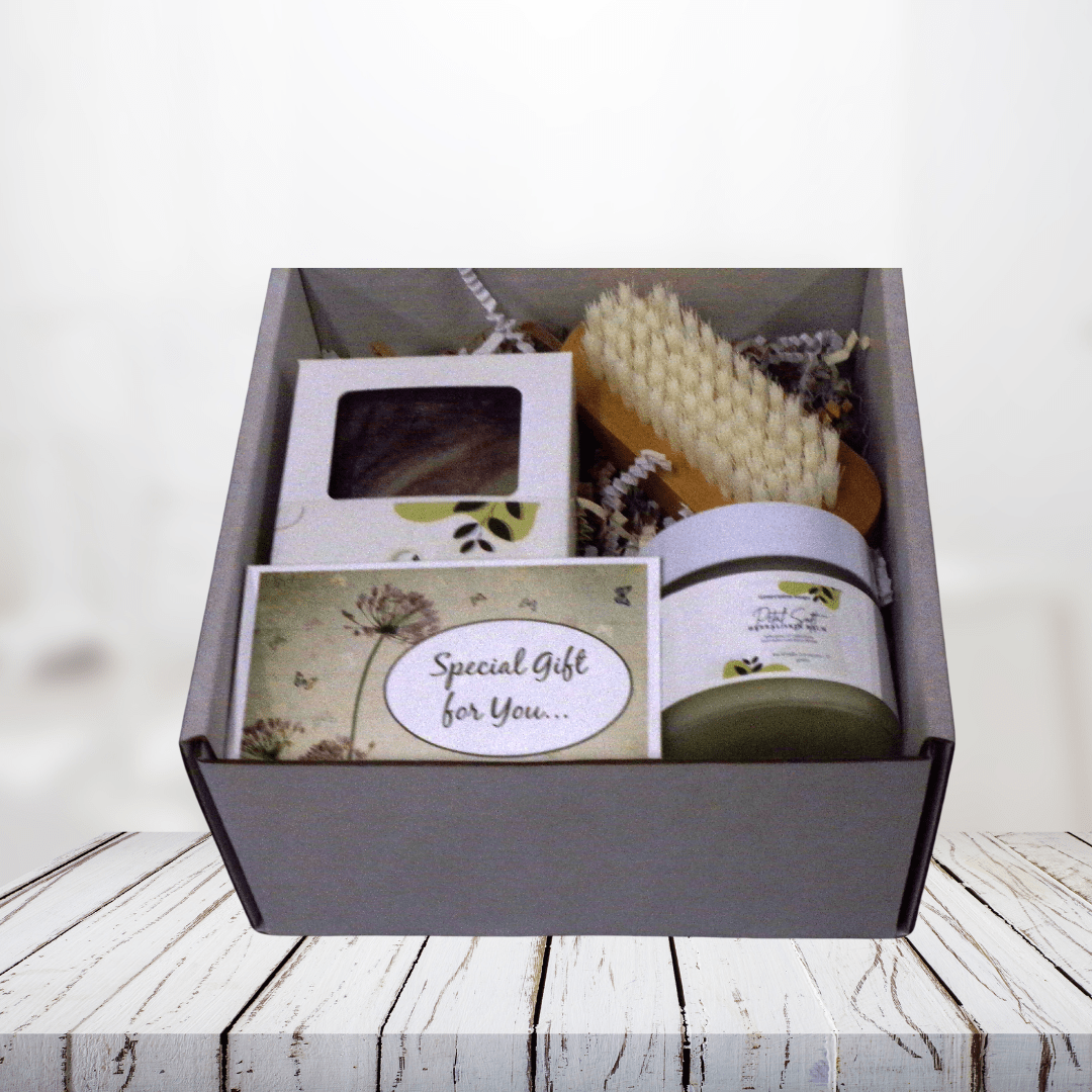 Petal Soft Hands & Body Gift Set with herbal soap, skin balm, and nail brush on a wooden surface.