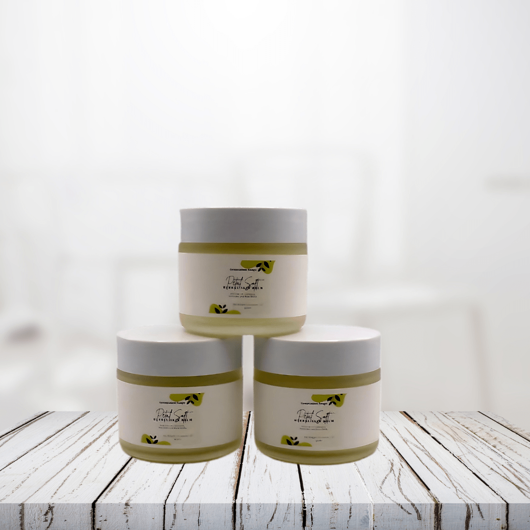 Petal Soft Herbal Skin Salve jars displayed on a wooden surface.